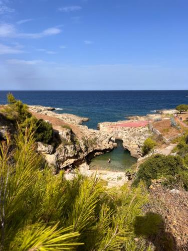 a view of the ocean with a rock formation at The Blue Window - Apartment - 300m from sea in Augusta