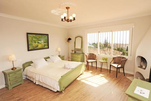 a bedroom with a bed and a table and chairs at Casa Ancladero Room W big balcony and lovely view in Fuengirola