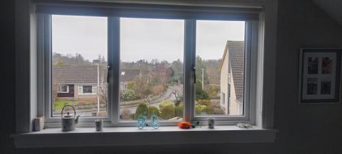 a kitchen window with a view of a street at Rooms by the Lade Braes & Doocot in St Andrews in St. Andrews