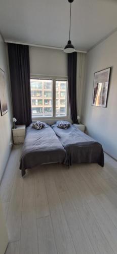 a large bedroom with two beds and two windows at Apartment in seaside Helsinki 83M2 with Sauna boat to Estonia 450 m from apartment in Helsinki