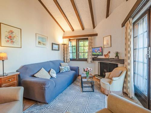a living room with a blue couch and a fireplace at Les Cassis in Nendaz