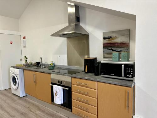 a kitchen with a sink and a stove top oven at Cantinho dos Sonhos in Santa Cruz