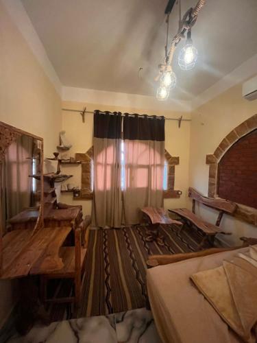 a room with a bed and a window with a curtain at Azru hotel siwa in Siwa