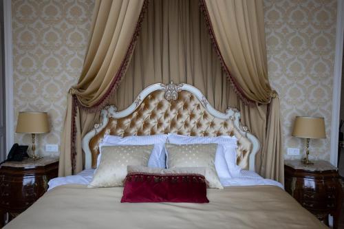 a bedroom with a large bed with a canopy at Winery La Gora in Irig