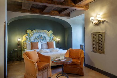 a bedroom with a king sized bed and two chairs at San Francesco al Monte in Naples