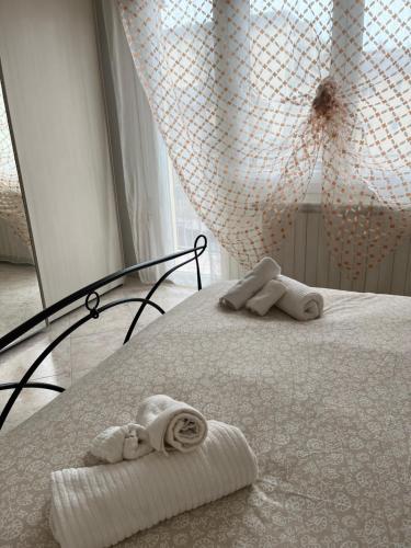a bedroom with a bed with towels on it at Siderea House in Chioggia