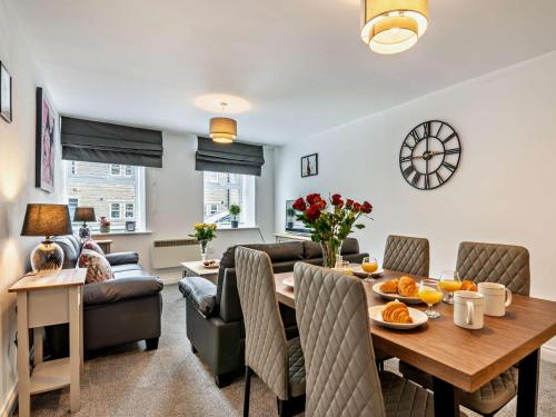 a living room and dining room with a table and a couch at 2 Bed in Holmfirth oc-95230 in Holmfirth