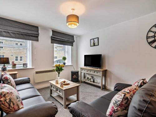 a living room with a couch and a tv at 2 Bed in Holmfirth oc-95230 in Holmfirth