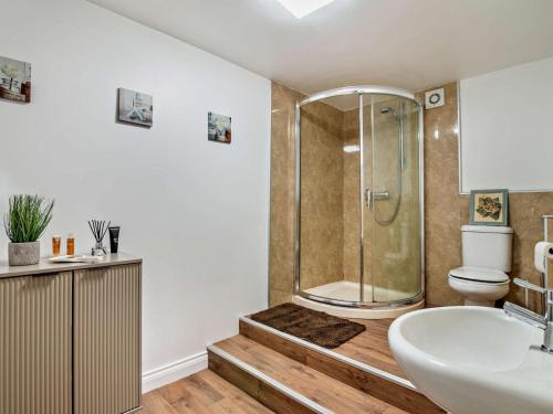 a bathroom with a shower and a sink and a toilet at 2 Bed in Holmfirth oc-95230 in Holmfirth