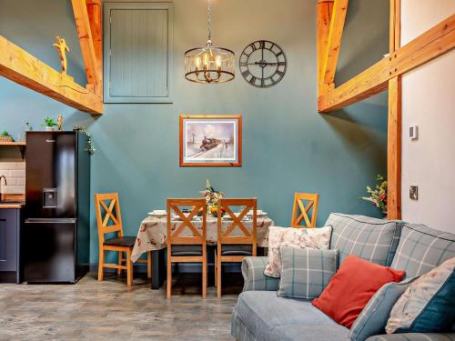 a living room with a couch and a table at 2 Bed in Ripon oc-94559 in Masham