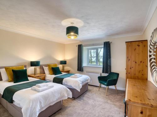 a bedroom with two beds and a window at 4 Bed in Dorchester oc-92413 in Frome Vauchurch