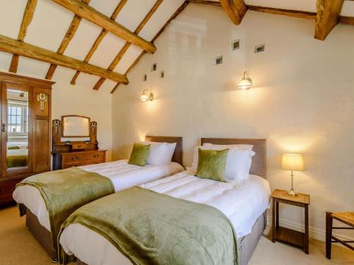a bedroom with two beds and a tv at 5 Bed in Harrogate oc-83663 in Summer Bridge