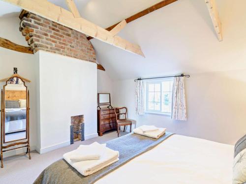 a bedroom with a bed and a brick wall at 2 Bed in Driffield oc-75583 in Lund
