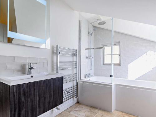 a bathroom with a sink and a tub and a shower at 2 Bed in Driffield oc-75583 in Lund