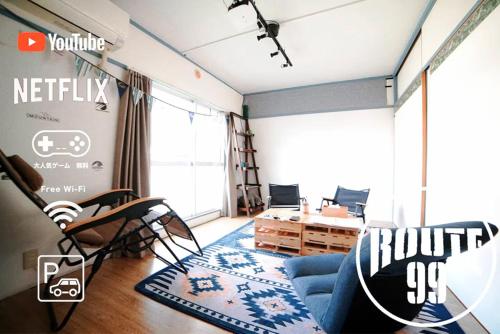a living room with a blue couch and a table at Hakone 8mins walk-campingstyle FreeNetflix Switch 104 in Hakone