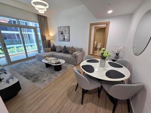 a living room with a table and a couch at 151 Residence Jumeirah Gardens in Dubai