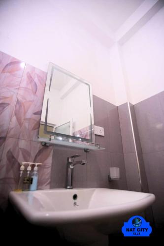 a bathroom with a sink and a mirror on the wall at NAT City Ella in Ella