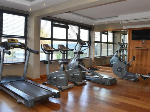 a gym with several exercise bikes in a room at Premier Hotel O.R. Tambo in Kempton Park