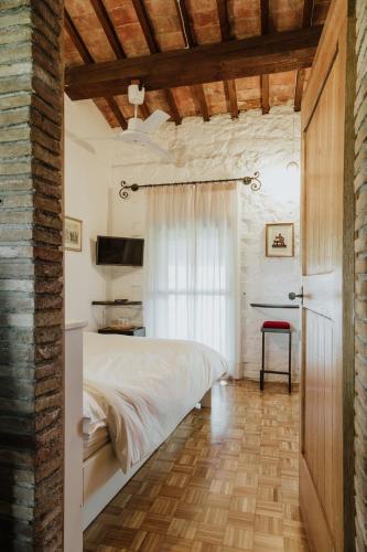 a bedroom with a white bed and a table at Il Paliarete in Orvieto