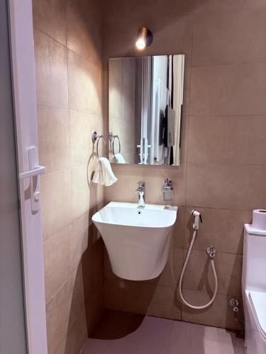 a bathroom with a sink and a mirror at Zanziluxe Residences in Zanzibar City