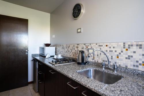 a kitchen with a sink and a counter top at Kube Apartments Express in Córdoba