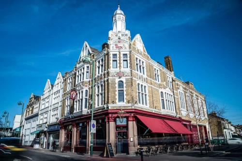 a large building with a tower on top of it at The Red Lion Hotel in London
