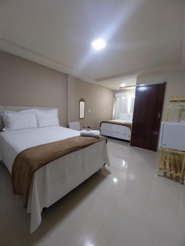 a bedroom with a large bed in a room at Pousada Serra do Torreão in João Câmara