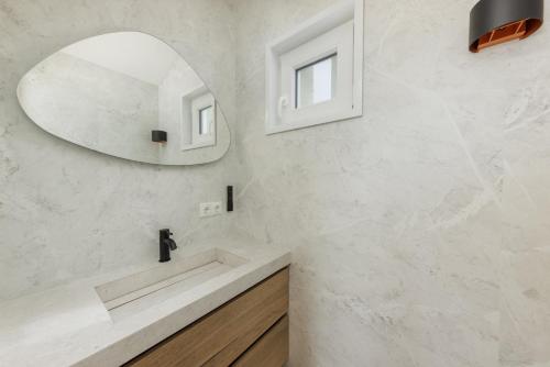 a bathroom with a sink and a mirror at Lua Beach House in Zandvoort