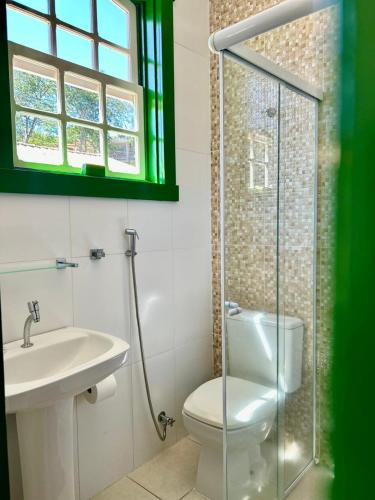 a bathroom with a toilet and a sink and a shower at Solar de Amelia in Tiradentes