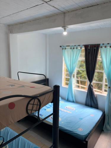 a bedroom with a bunk bed and a window at Hostal Casa LUCY in Yumbo
