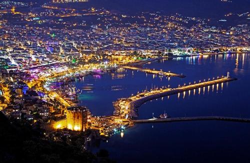 an aerial view of a city at night at Belle Ocean Apart Otel in Alanya