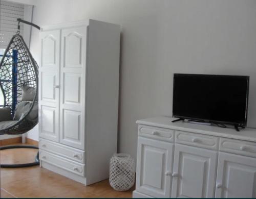 a white cabinet with a television on top of it at AlgarveInn in Altura