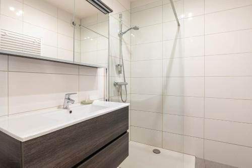 a bathroom with a sink and a shower at Mercator 0301 in Ostend