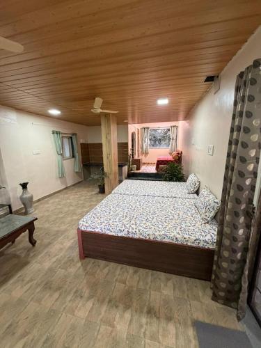 a bedroom with a large bed in a room at Umang Homestay in Talegaon Dābhāde