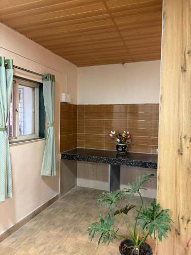 a room with a counter with flowers in it at Umang Homestay in Talegaon Dābhāde