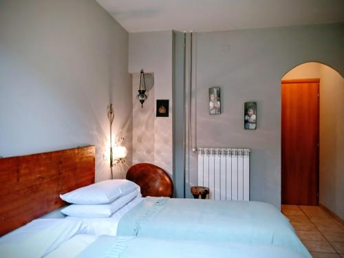 a bedroom with a white bed and a chair at B&B Franciacorta in Castrezatto
