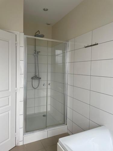 a shower with a glass door in a bathroom at Maison de ville in Lannion