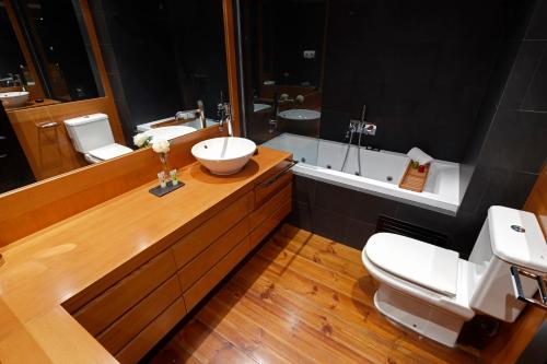a bathroom with a sink and a toilet and a tub at Pleta de Nheu 2 by FeelFree Rentals in Baqueira-Beret