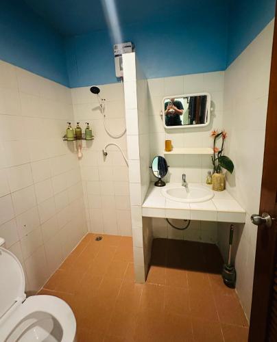 a bathroom with a toilet and a sink and a shower at MILD ISLAND STAY ROOm in Phi Phi Islands