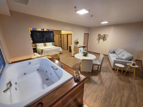 a large living room with a large tub in a room at Hotel São Francisco in Penedo