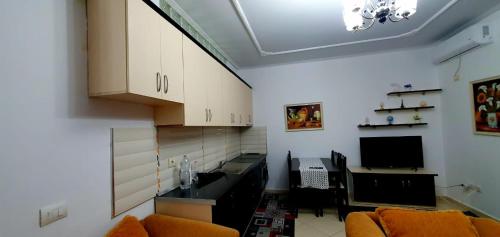 a kitchen with a couch and a table and a tv at Apartament martin 3 in Vlorë