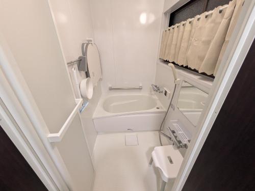 a small bathroom with a toilet and a sink at happy stay HANA in Sakaide