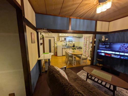 a living room with a couch and a table at happy stay HANA in Sakaide