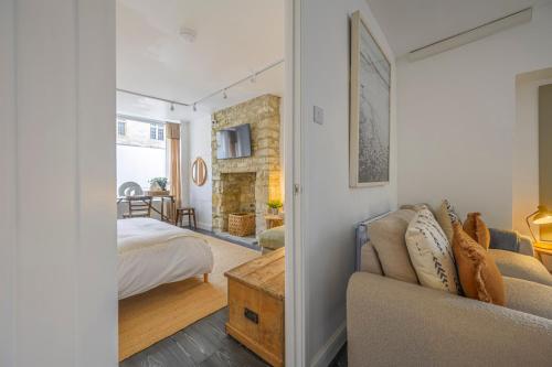 a living room with a couch and a bedroom at New The Barley Rustic luxury in Cirencester