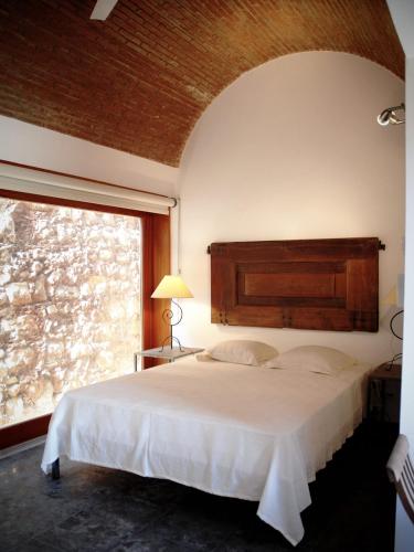 a bedroom with a large bed and a window at Forte De Sao Joao Da Barra in Cabanas de Tavira