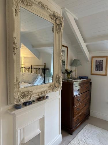 a mirror on top of a dresser in a room at Trewetha Cottage Bed & Breakfast in Port Isaac