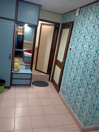a bathroom with a blue and white wall at relax in Shimla