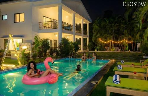 a group of people in the swimming pool of a house at Ekostay Luxe - CASA SIA - Ideal for Big Groups- Poker Table in Lonavala