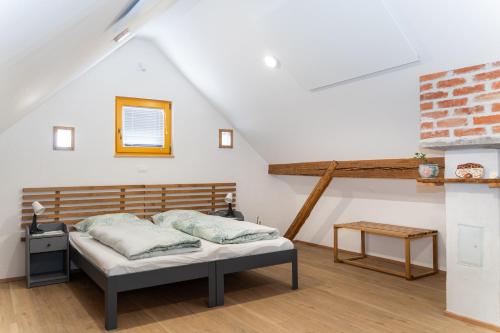 a bedroom with a bed in a attic at Timeless Barn in Ljubljana