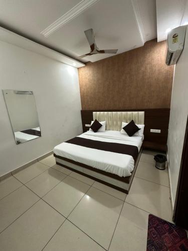 a bedroom with a bed in a room at Divine Hotel in Zirakpur